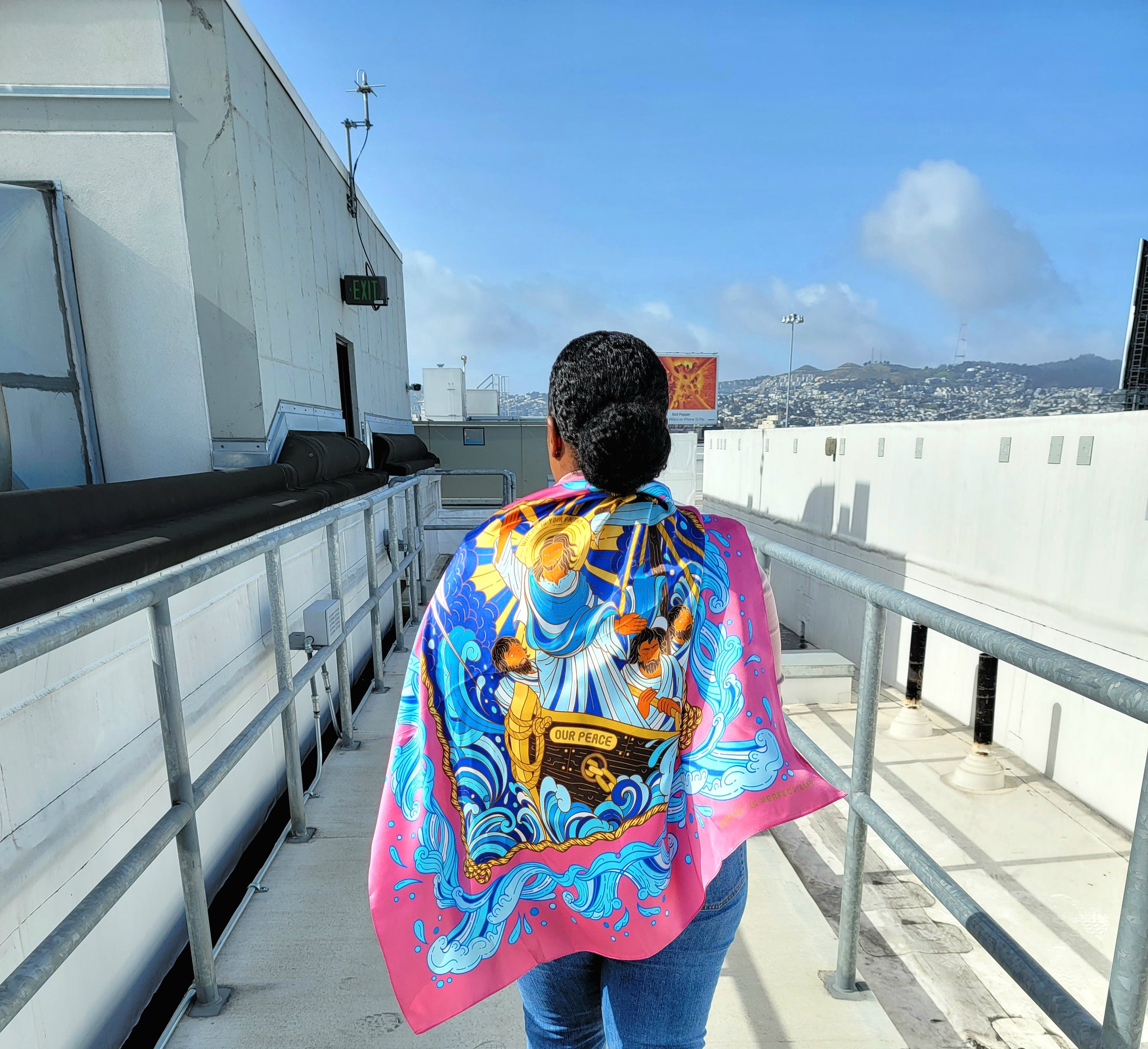 Person on roof top with scarf behind them